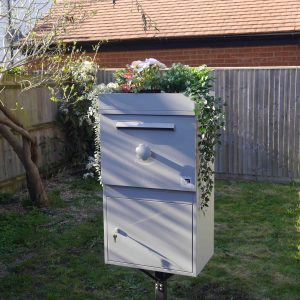 A Large parcel box, with a garden roof, in a garden.JPG